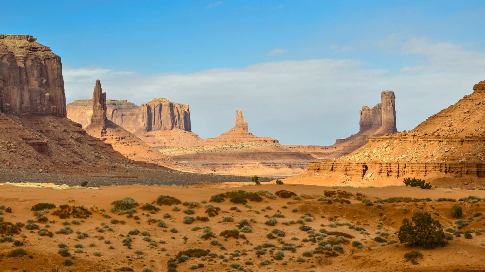 Red sandstone buttes rising from open high-desert terrain