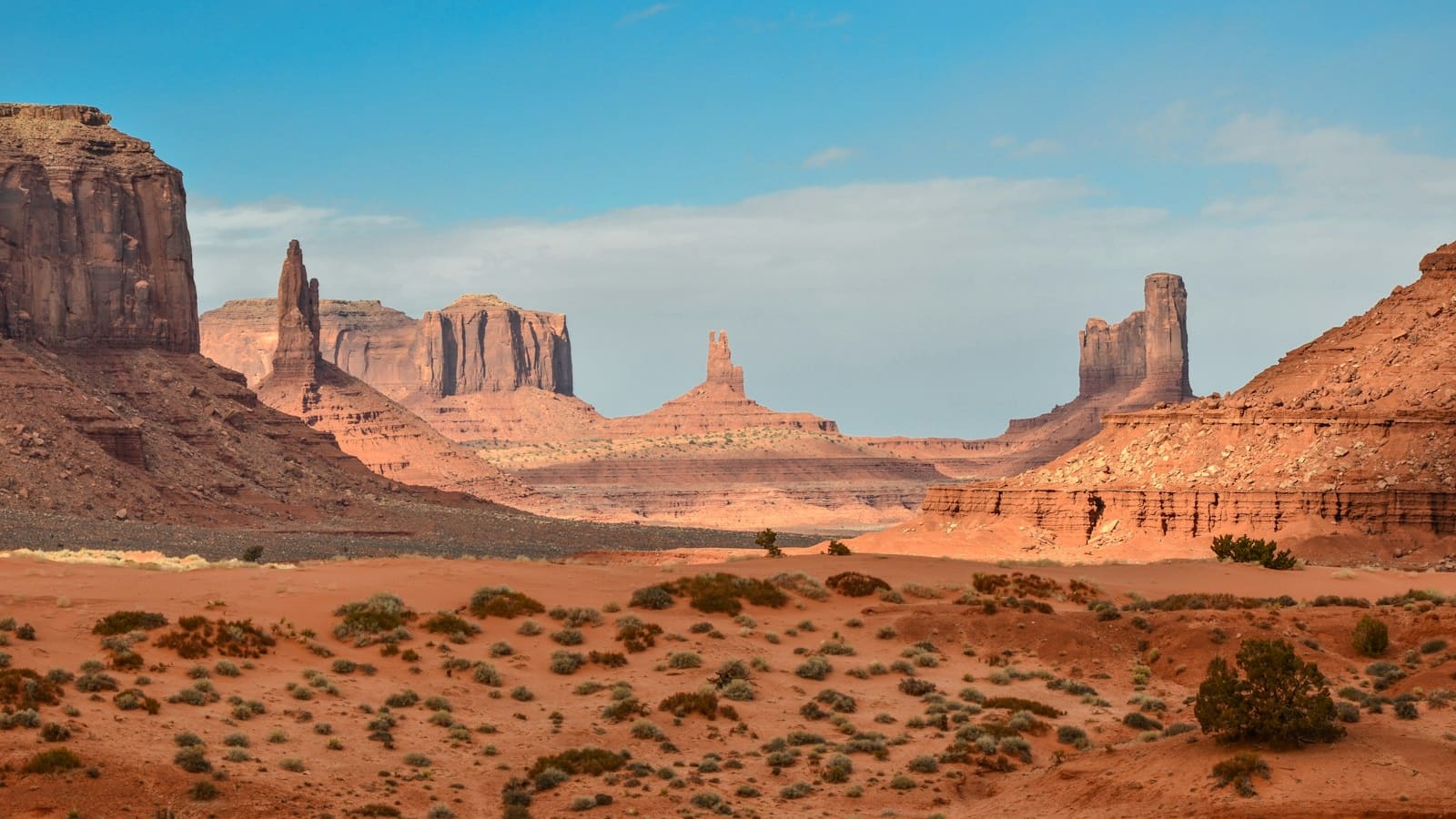 Red sandstone buttes rising from open high-desert terrain